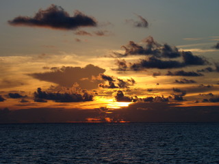 A beautiful and romantic sunset at the Maldives seen from a luxurious villa. Holidaying in Maldives without seeing a sunset is a bit like going to Paris without seeing the Eiffel Tower.