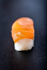 salmon sushi on a black background