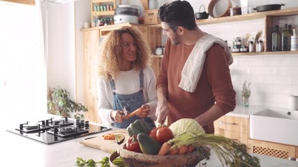 Couple preparing food in kitchen. - Powered by Adobe