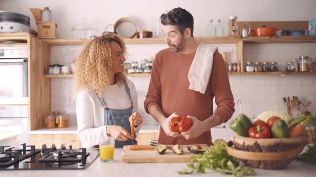 Couple preparing food in kitchen.