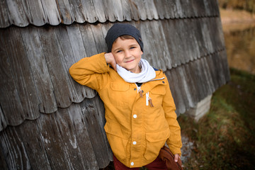 Happy child boy in warm jacket in autumn. Kids fashion, childhood, lifestyle. Happy autumn holidays.