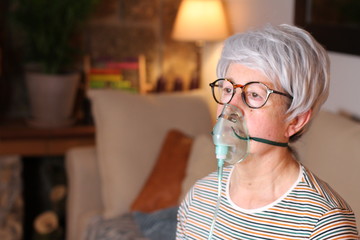 Senior woman receiving oxygen therapy 