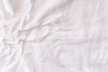 Rough wet crumpled white linen fabric background texture frontal view.