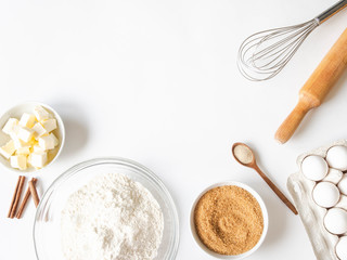 Frame of various baking ingredients - flour, eggs, sugar, butter, dry yeast, nuts and kitchen...