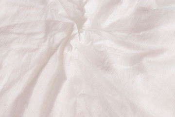 Rough crumpled white linen background texture close up frontal view.