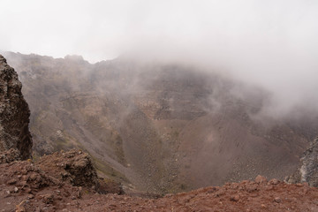Vesuvius Crater in the clouds in cloudy weather, Italy