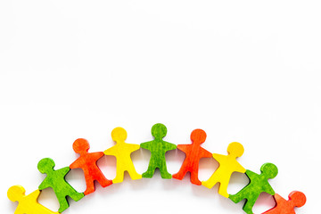 Tolerance, human rights, anti-discrination concept. Wooden figures of people on yellow table, top view