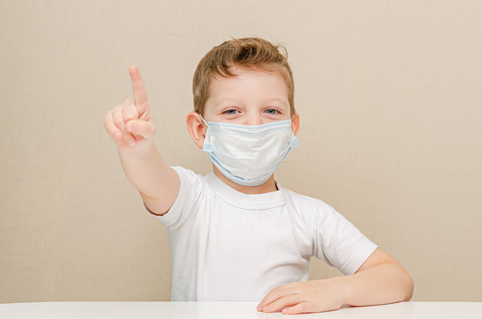 Cute boy of four years in a medical mask. Quarantined children due to an epidemic. The boy got an idea.