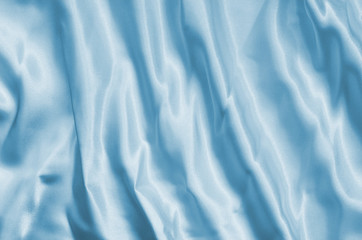 Naklejka premium Closeup of rippled light blue silk fabric lines