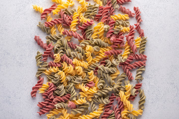 Multicolored pasta background concept on gray background. Diet and healthy food concept