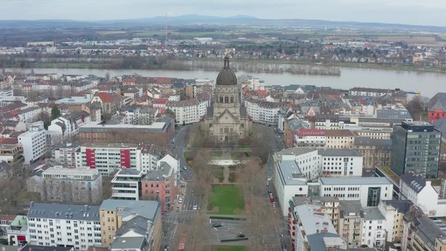 Aerial panorama fly over cinematic shot of the christus church and the kaiserstraße in mainz with the river rhine in the background 30p
