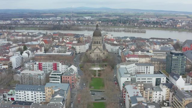 Aerial panorama fly over cinematic shot of the christus church and the kaiserstraße in mainz with the river rhine in the background 25p