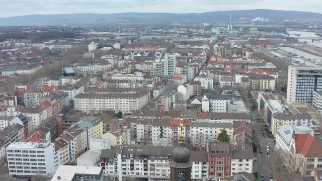Aerial / drone panorama top rotating cinematic shot of Mainz and the christus church at the kaiserstraße in mainz with the river rhine in the background 25p