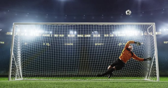 Goalkeeper saves from a goal on the empty soccer stadium. No spectators on the tribunes. Stadium is made in 3D.