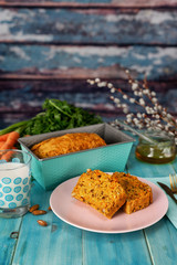 Vertical shot of vegan carrot cake on aqua menthe blue background