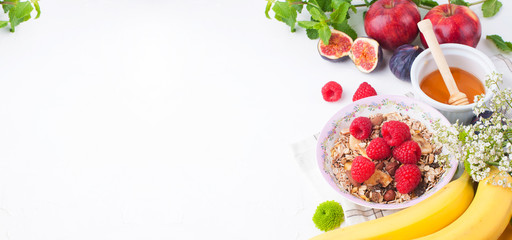  Healthy food background with homemade oatmeal granola or muesli with yogurt and fresh berries for healthy morning breakfast,Muesli, figs, raspberries, apples, honey. top view, copy space. Banner