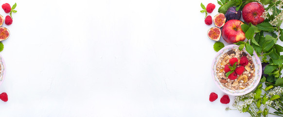 Fototapeta na wymiar Healthy food background with homemade oatmeal granola or muesli with yogurt and fresh berries for healthy morning breakfast,Muesli, figs, raspberries, apples. top view, copy space. Banner.Long format