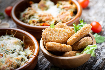 chicken nuggets with ketchup on a plate on a rustic table
