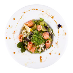 Salmon and seaweed salad on a white plate Isolated on a white background. Serving in a restaurant.