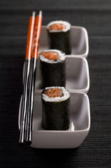 Sushi rolls uramaki with chopsticks