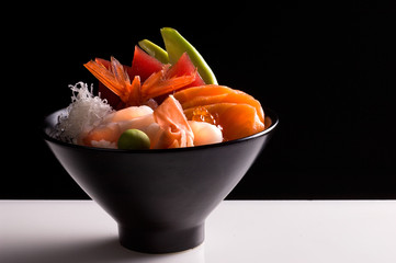 Poke bowl, chirashi with fresh fish isolated on black