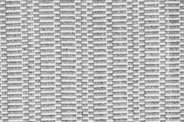 Woven rug texture, close-up. Grey and white textile background