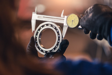 the abstract image of the technician maturing the ball bearing in the industrial factory. the concept of clean energy, futuristic, industrial4.0 and internet of things. - obrazy, fototapety, plakaty