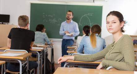 Young girl is sitting at the desk
