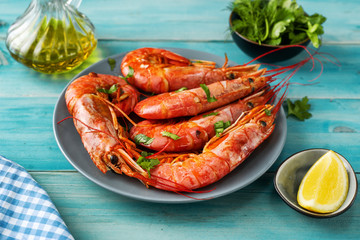 Close up of huge argentinian red prawns on aqua menthe background
