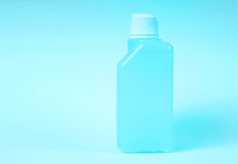 Coronavirus prevention. Hand sanitizer in the bottle on a blue background.