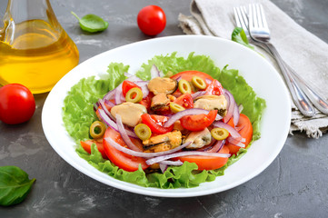 Salad of marinated mussels, fresh tomatoes, red onions, olives in a white bowl