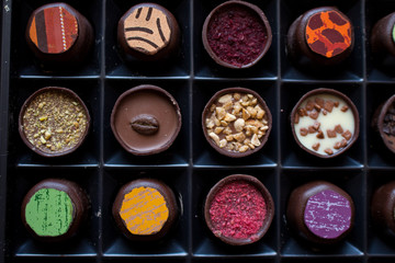Various of sweet confectionery with chocolate candies and pralines. Handmade box of chocolates. Realistic chocolate set, delicious dessert pattern.