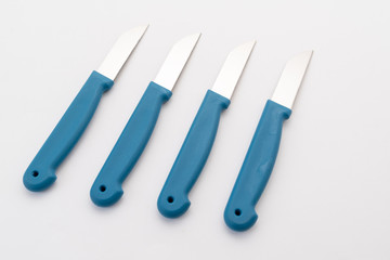 four sharp knives with blue plastic handle on white background