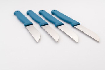 four sharp knives with blue plastic handle on white background