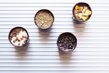 Various of sweet confectionery with chocolate candies and pralines. Handmade box of chocolates. Realistic chocolate set, delicious dessert pattern.