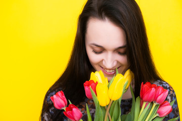 Obraz na płótnie Canvas Birthday girl with flowers smiles. Birthday. Women's Day. March 8.