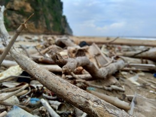 Rubbish in the beach make looks dirty and messy. the pollution because many plastic, wood and others waste.