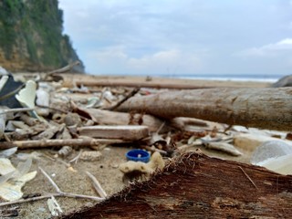 Rubbish in the beach make looks dirty and messy. the pollution because many plastic, wood and others waste.
