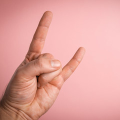 Rock and roll hand sign on clear color background