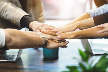 Obraz na płótnie Canvas Close up business people connect joining hands together, Stack of hands, Teamwork partner concept.