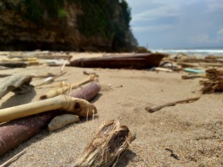 Rubbish in the beach make looks dirty and messy. the pollution because many plastic, wood and others waste.