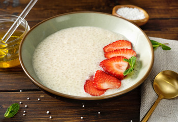 Vegan tapioca pudding in a plate on dark rustic background
