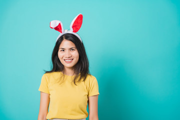 woman smile white teeth wear yellow t-shirt standing with bunny ears her looking to space