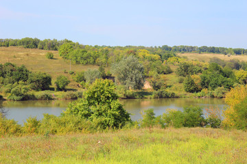Beautiful nature, green trees near blue lake in Talova Balka village near Svetlovodsk city, Kirovohrad region, Ukraine. Ukrainian nature. Travel concept. Countryside