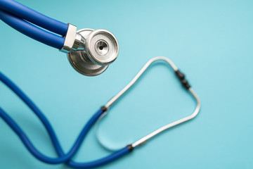 Stethoscope on blue background, top view. Medical instrument