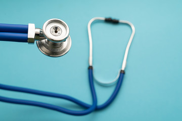 Stethoscope on blue background, top view. Medical instrument