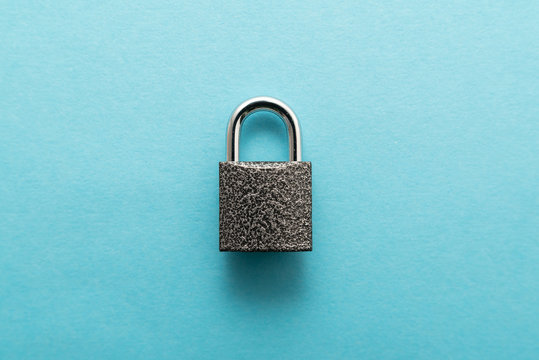 Metal lock isolated on blue background.