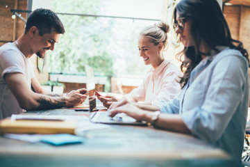 Successful hipster team of coworkers busy with gadgets