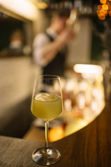 Celery cocktail in a wine glass with cube of ice