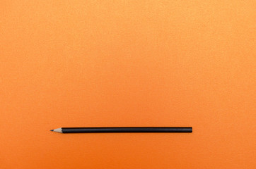Pencil on blank orange textured paper